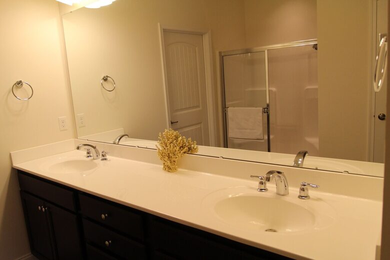 Main floor primary full bathroom, double vanity, private toilet area