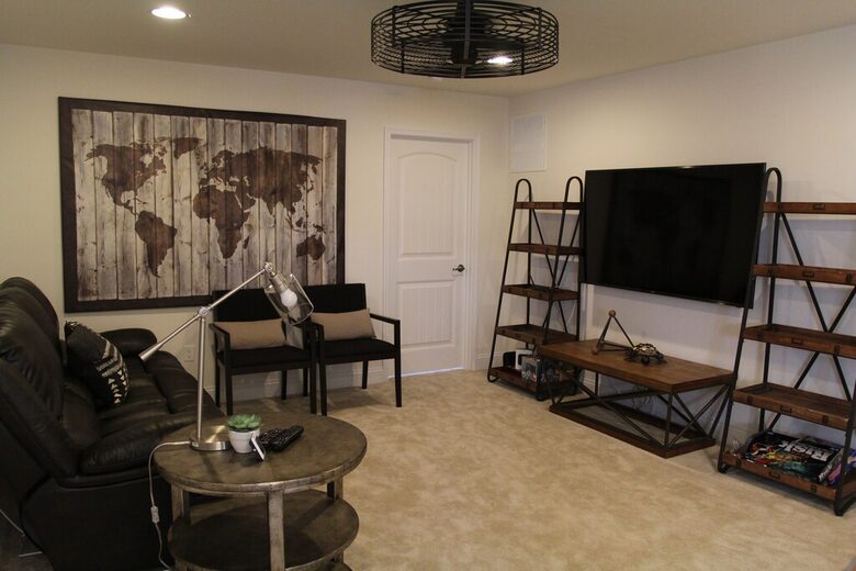 Large loft area with reclined sofa, streaming device on TV, full bath