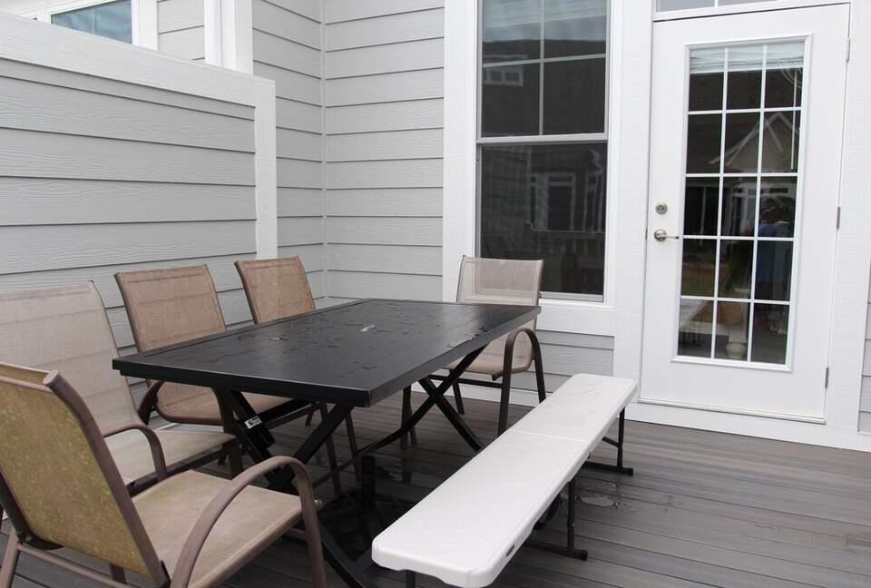 Deck area with gas grill off of screened in porch and primary bedroom