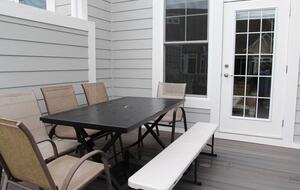 Deck area with gas grill off of screened in porch and primary bedroom