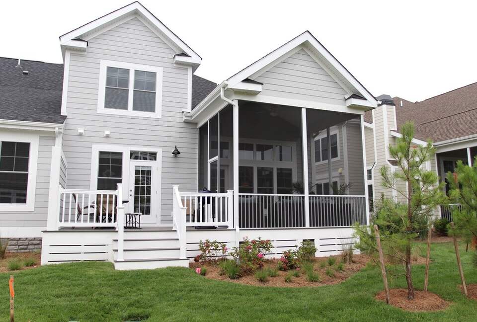 View of back of house with screened in porch and deck, gas grill