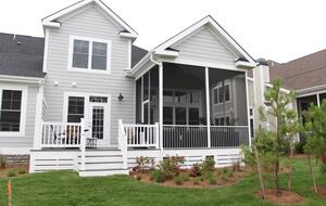 View of back of house with screened in porch and deck, gas grill