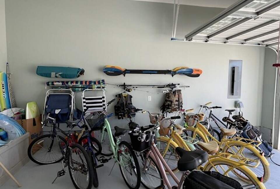 Tons of bikes and beach stuff, foosball, mini fridge, EV charger,