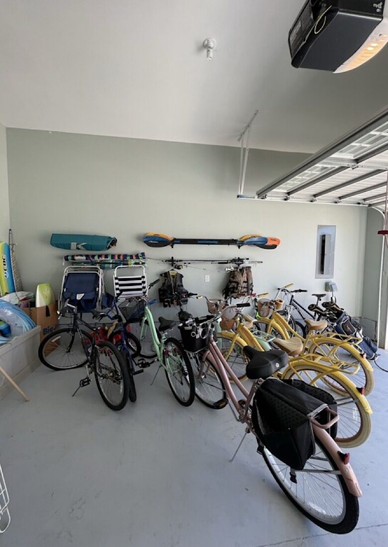 Tons of bikes and beach stuff, foosball, mini fridge, EV charger,