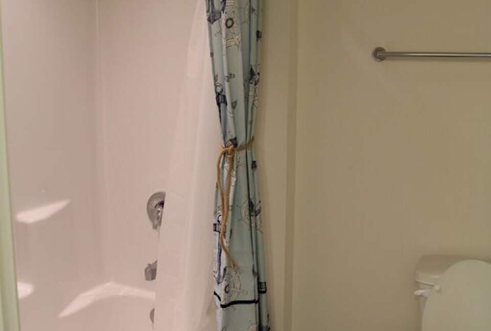 Loft bathroom with double vanity, separate area for toilet and shower