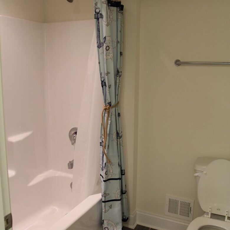 Loft bathroom with double vanity, separate area for toilet and shower