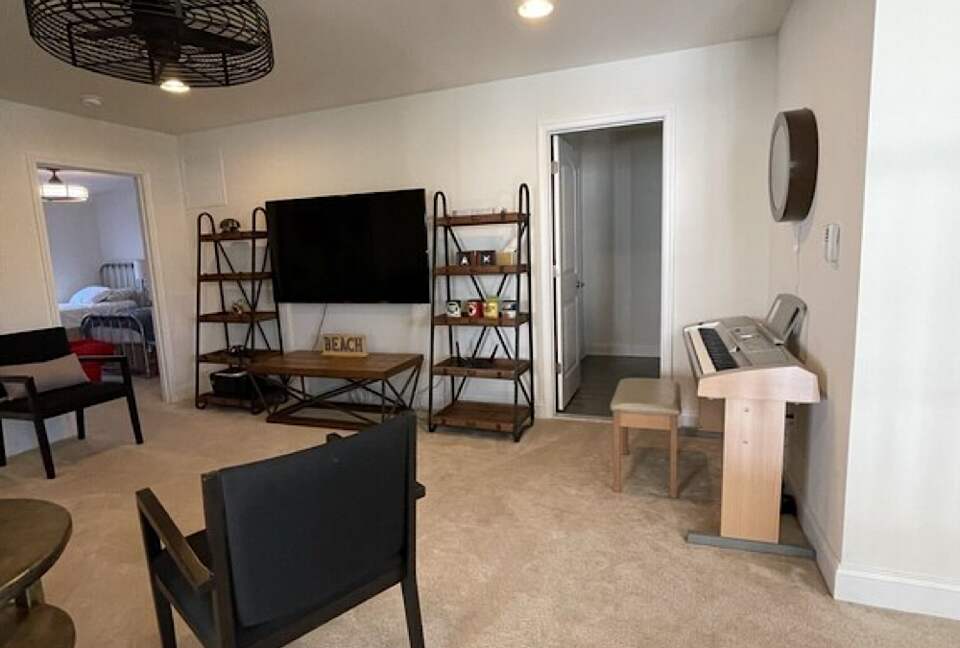 Large loft area with reclined sofa, digital keyboard, full bath