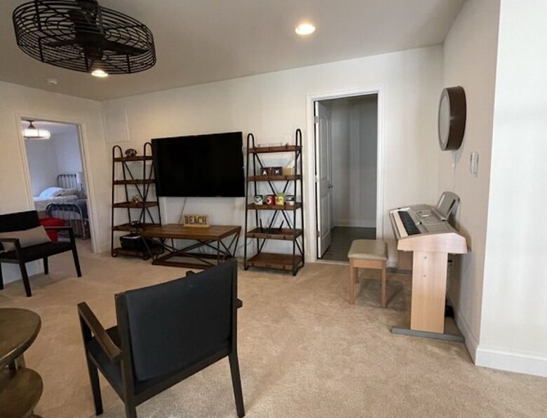 Large loft area with reclined sofa, digital keyboard, full bath