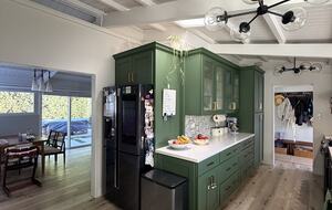 Kitchen view with Skylight and Refrigerator.