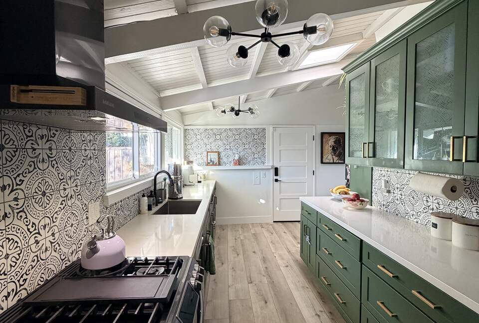 Kitchen view with range and sink looking towards Garage.