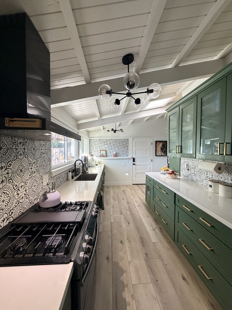 Kitchen view with range and sink looking towards Garage.