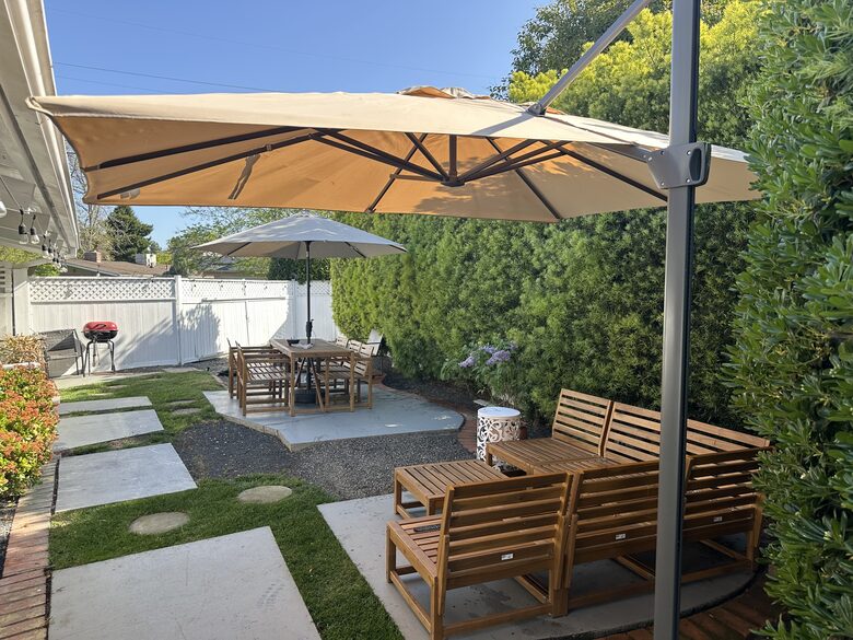 Backyard view of Couch and Table. Both underlit and cushions
