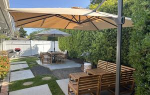 Backyard view of Couch and Table. Both underlit and cushions