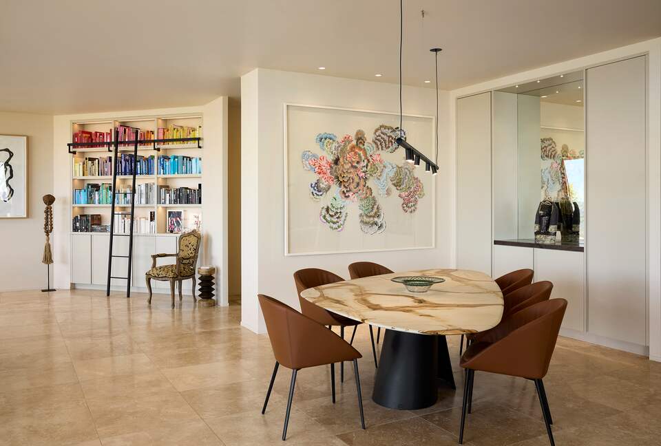 Dining room with bookshelf in lounge beyond