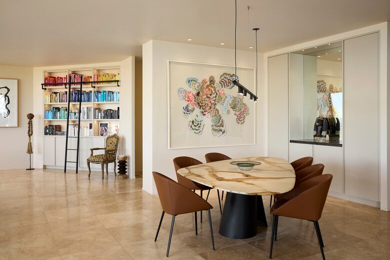 Dining room with bookshelf in lounge beyond