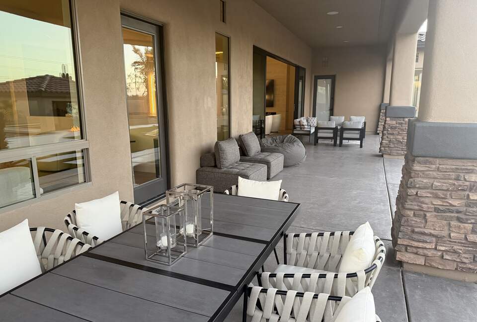 Covered patio with dining table and seating areas
