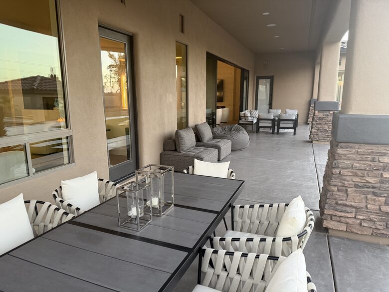 Covered patio with dining table and seating areas