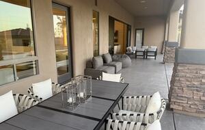 Covered patio with dining table and seating areas