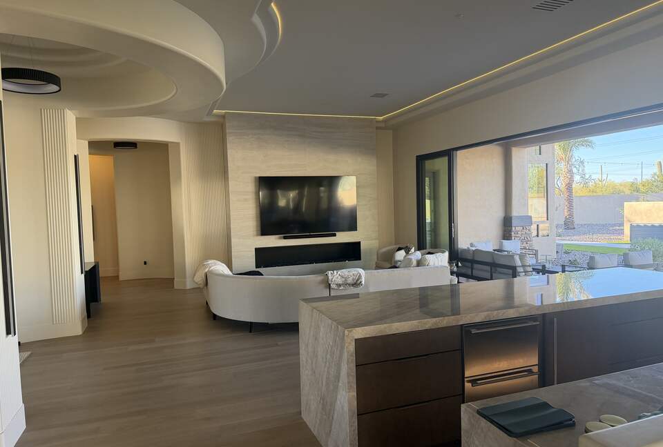 Multi slide panoramic doors completely open. Fireplace and 100 inch TV