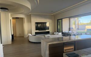 Multi slide panoramic doors completely open. Fireplace and 100 inch TV