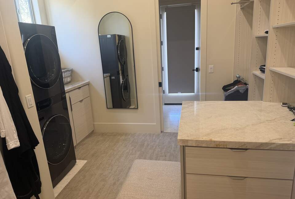 Master closet with additional laundry and access to Pool