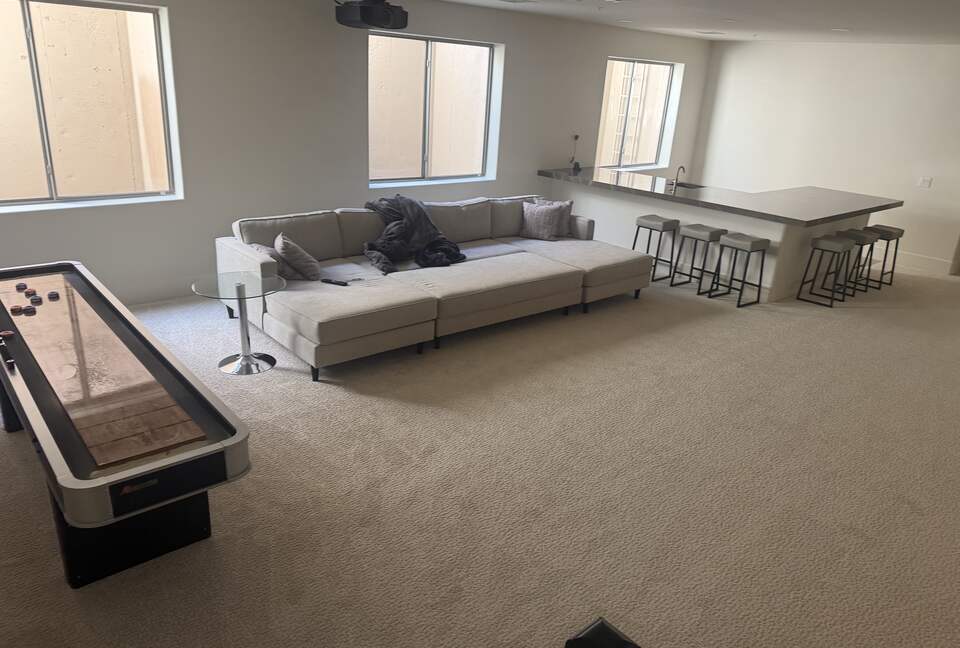 Full basement with bar, projector TV and shuffleboard