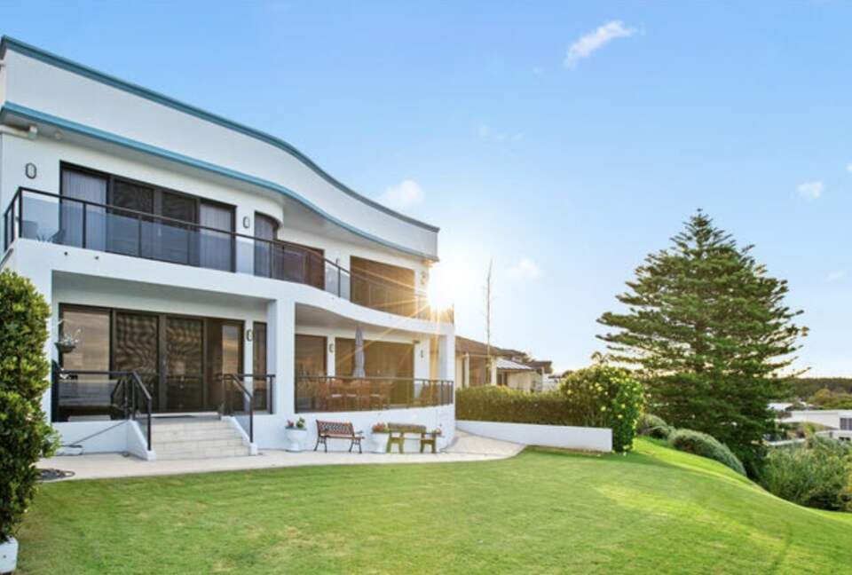 Balconys on both levels face the ocean. Bottom level with teak chairs
