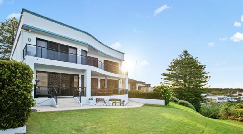 Balconys on both levels face the ocean. Bottom level with teak chairs