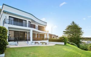 Balconys on both levels face the ocean. Bottom level with teak chairs