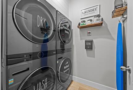 Laundry room with 2 full sized washers and dryers