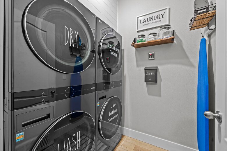 Laundry room with 2 full sized washers and dryers