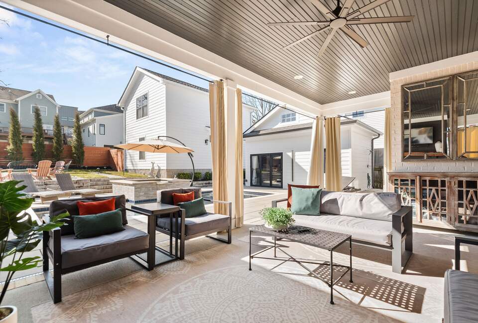 outdoor patio area with pool towels, lots of seating, fireplace