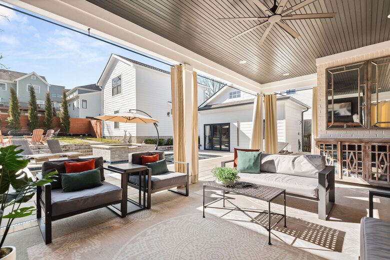 outdoor patio area with pool towels, lots of seating, fireplace