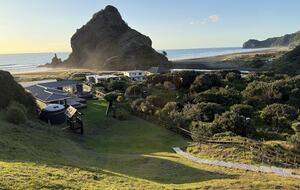 View of Lion Rock over house from crest of dune on property