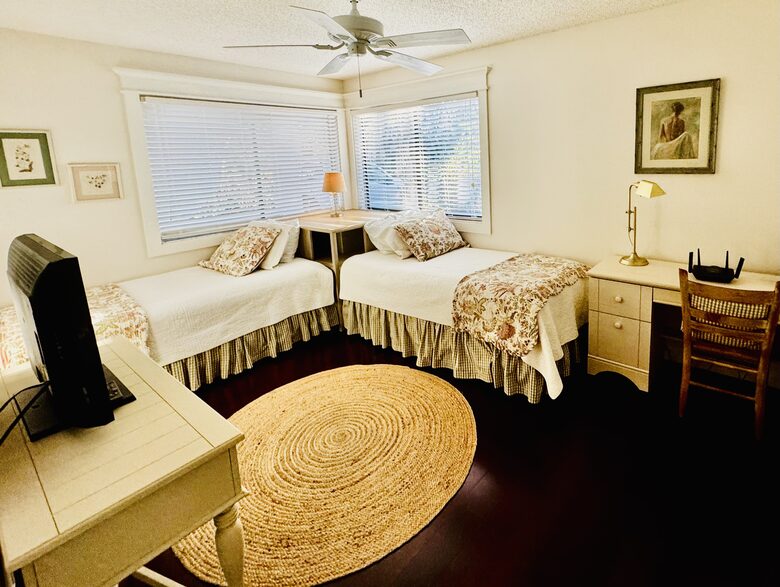 third bedroom with two twin beds and a desk