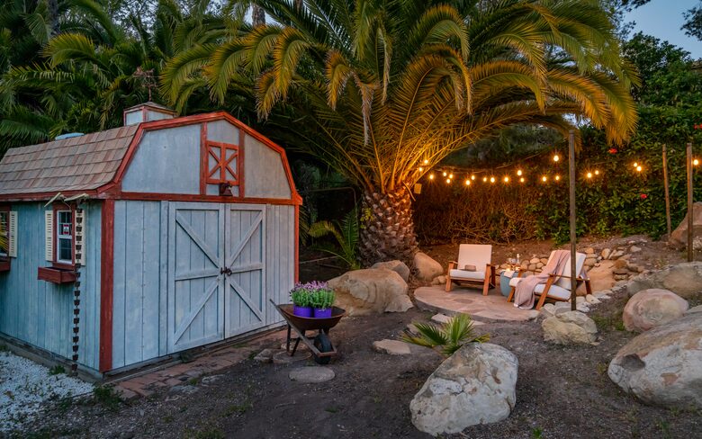 Barn-style shed with a relaxing seating area next to the creek