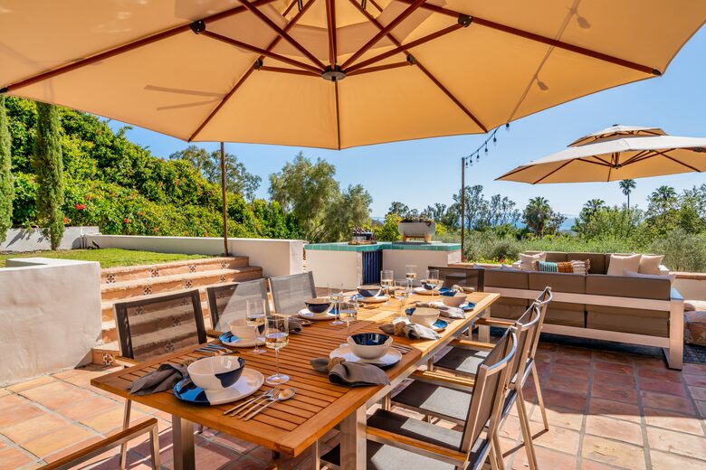 South side patio with multiple sitting options and views of the ocean