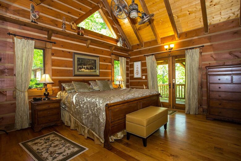 Primary bedroom with King bed. Doors lead to side deck.