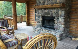 Back deck with river rock, wood burning fireplace