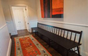 The hallway with art adjoining the guest bedrooms.