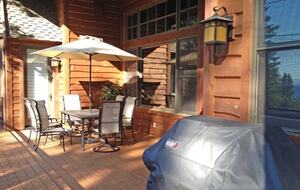 Great wraparound deck, with bbq, dining table, lounge chairs and view