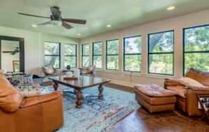 Open living room with view of the Blanco River