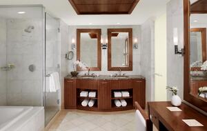 Spacious bathroom with separate tub and glass shower