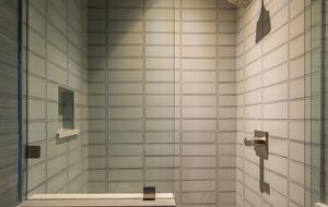 Main floor family room glass-enclosed walk-in shower.