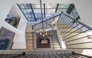 View from second floor stairs looking down to bottom floor.