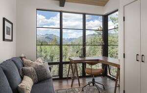 Private reading room with desk, sofa, and mountain views.