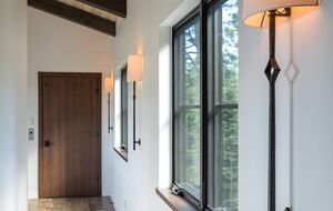 Upstairs hallway with windows and elevator door.