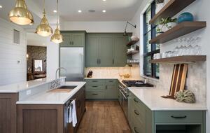 Full kitchen with white counters & sage & wood cabinetry