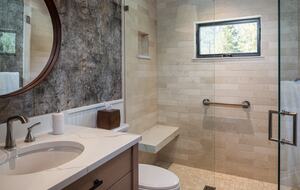 Guest room full bath with sink, toilet, and walk-in shower.