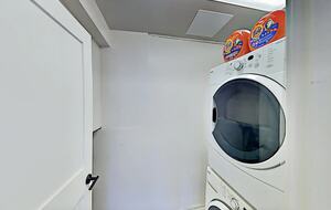 Laundry room with stacked washer and dryer